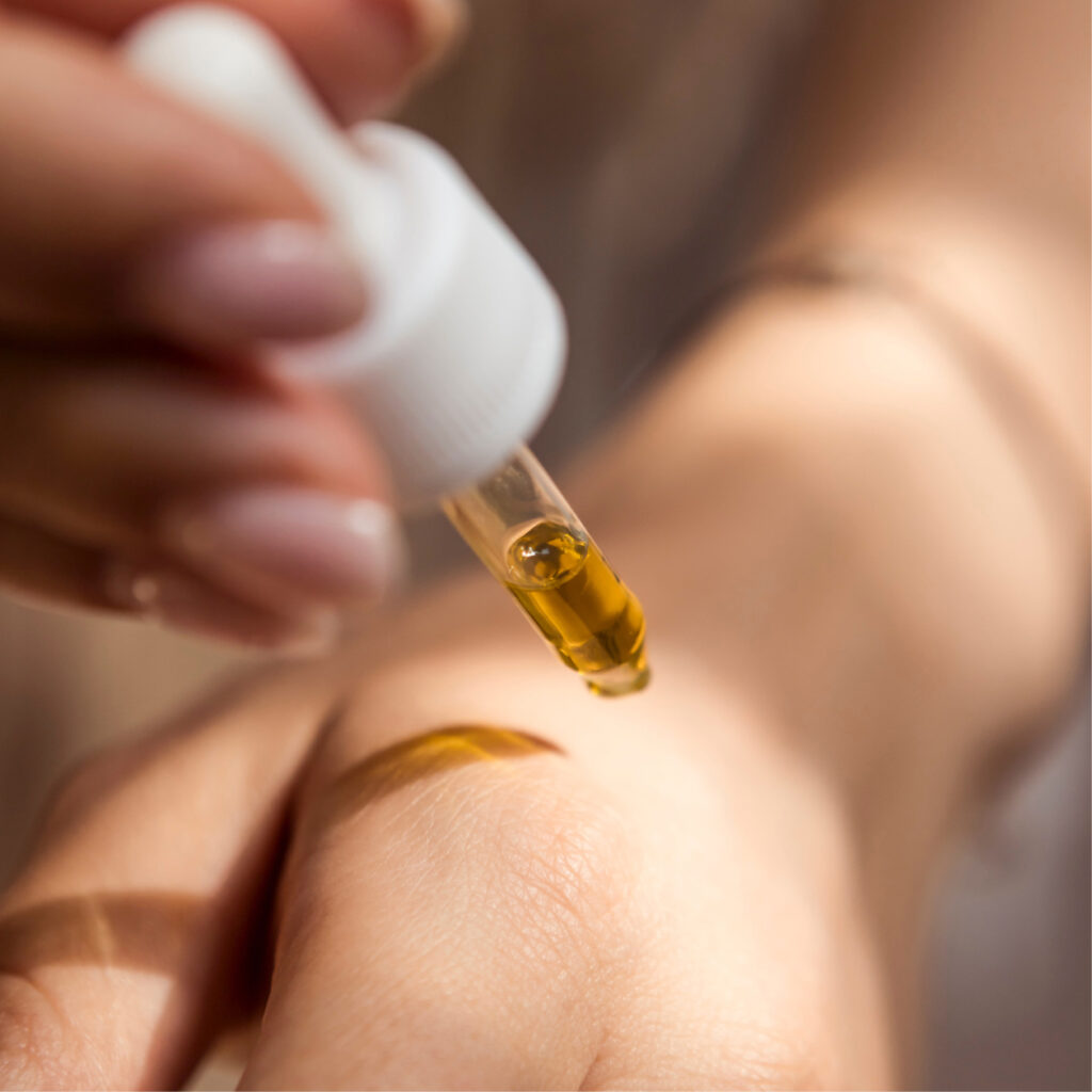 Close-up of pure, cold-pressed neem oil in a glass bottle, rich in antibacterial and antifungal properties for skincare and haircare.